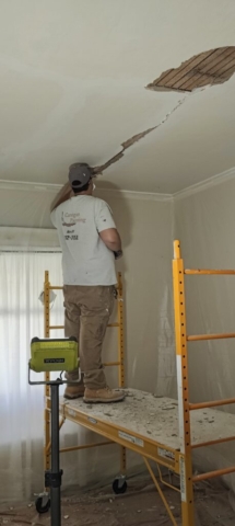 Dave Carrigan Jr repairing damaged plaster ceiling