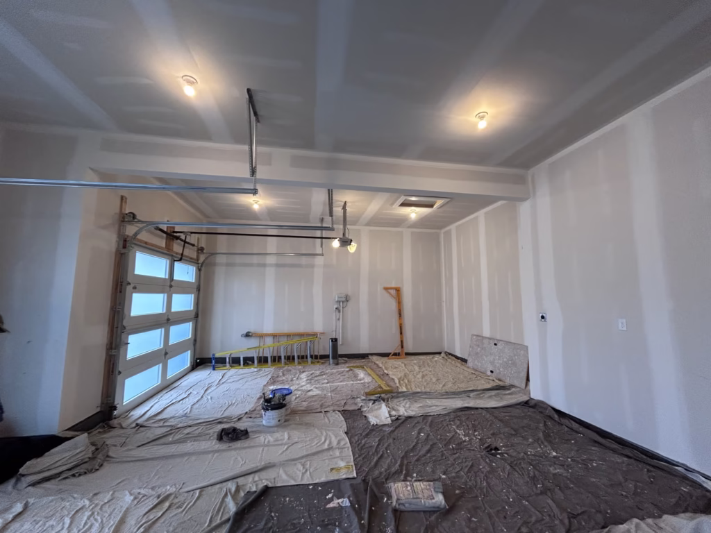 Unprimed drywall walls and ceiling in a residential two car garage in a new home in Clarence Center, NY.