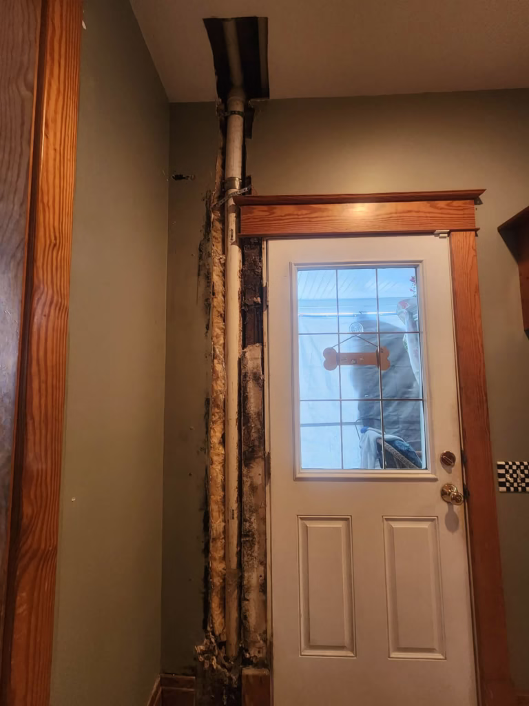 Hole in wall next to door