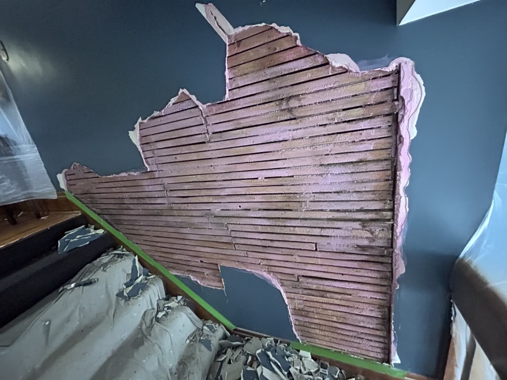 plaster bulge removed exposing wood lath