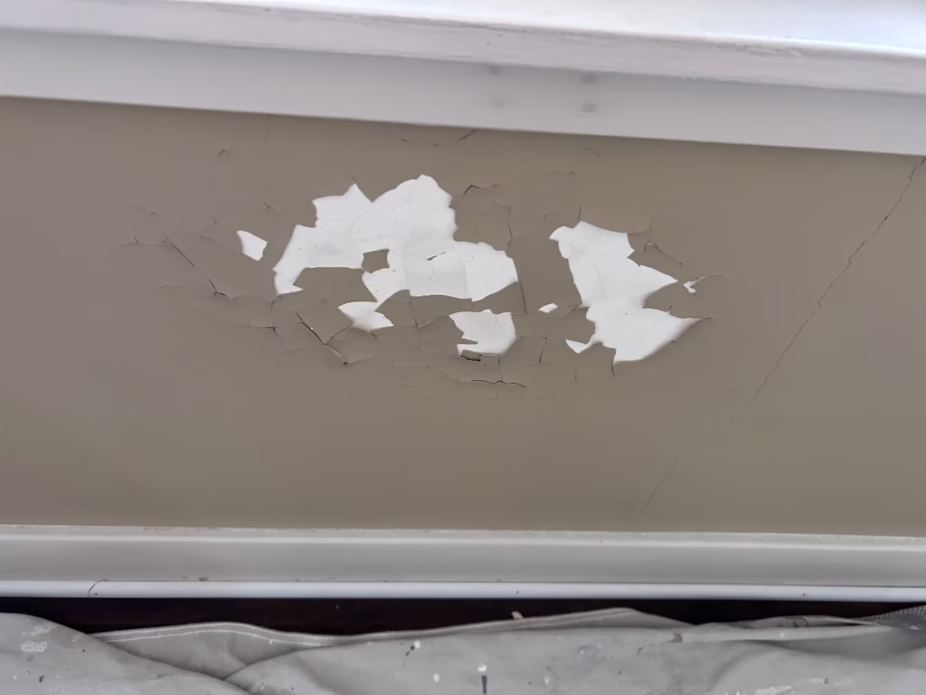 Getzville NY: Ceiling Restoration and Painting - The Carrigan Archives water damaged plaster under a window