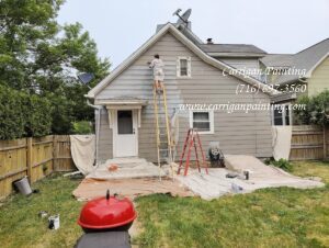 Painting the siding of a home in WNY