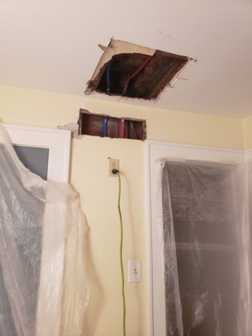 Hole in wall and ceiling from plumber