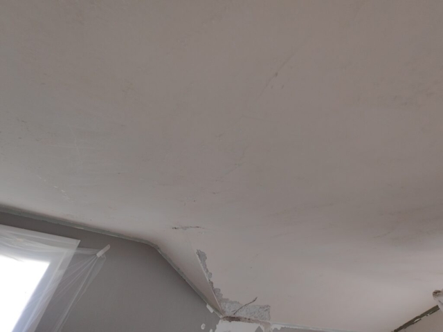 cracks in plaster ceiling. Evidence of water damage