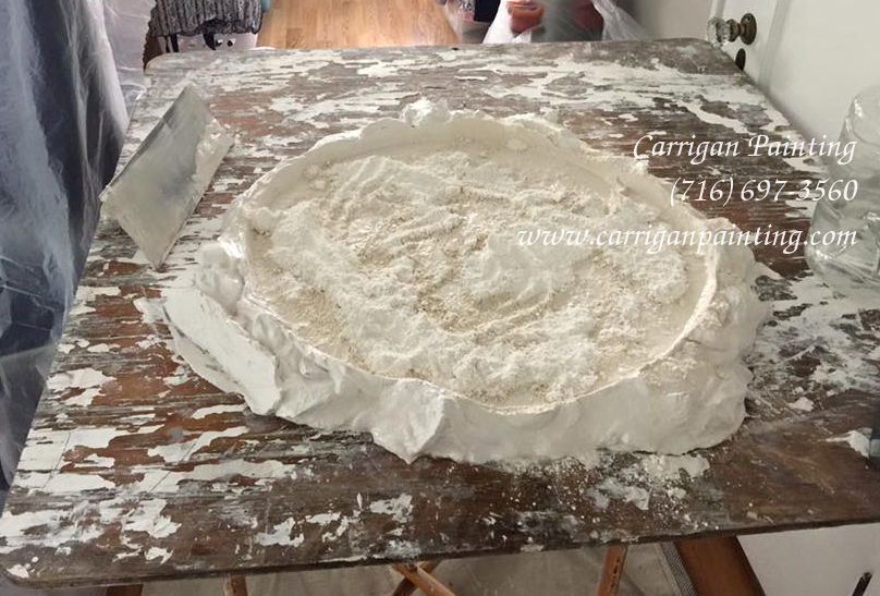 Pre-mixed lime putty and plaster of Paris on mortar board ready for plaster repair in Williamsville New York