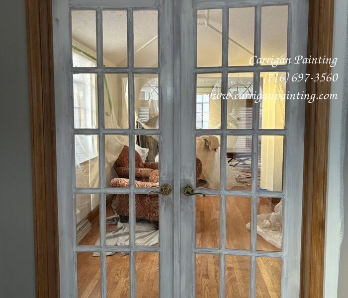 Natural wood french doors primed with paint.