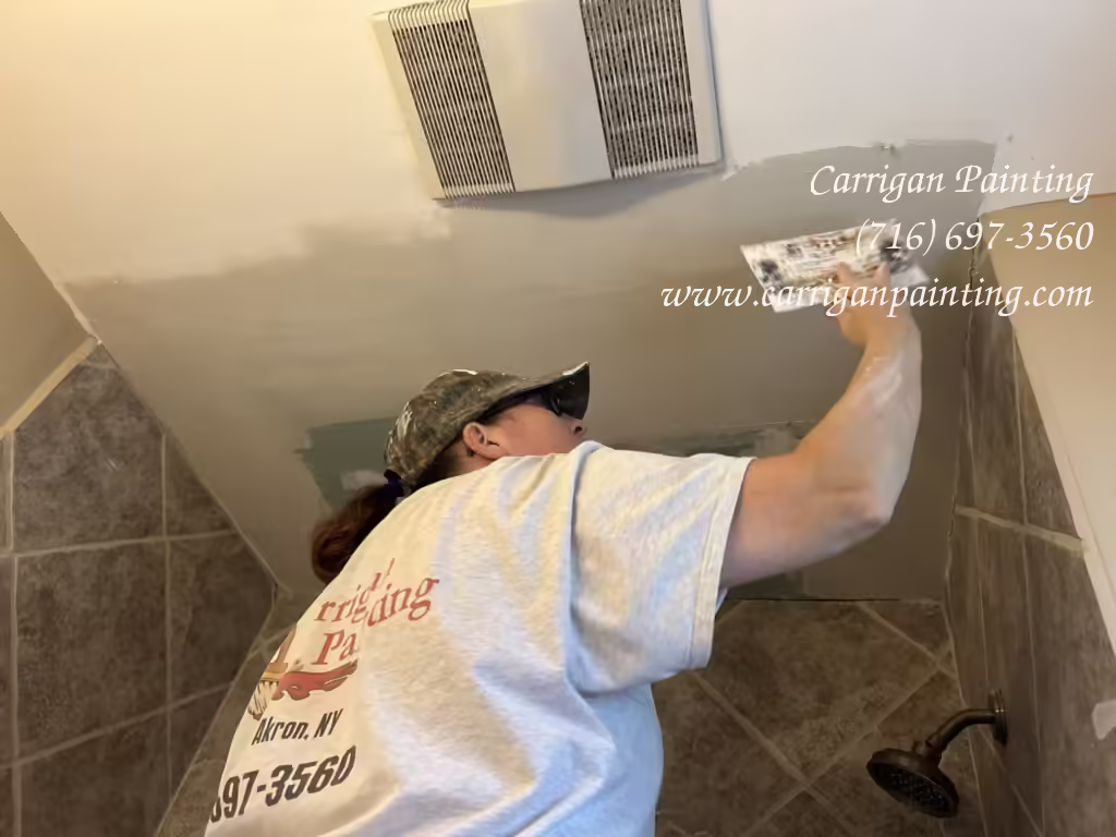 Bathroom Ceiling Repair in Williamsville - The Carrigan Archives finishing a drywall ceiling patch in a bathroom in a Williamsville home.