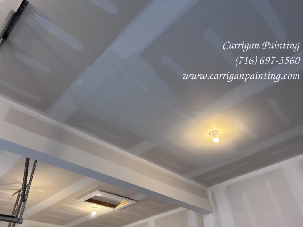Drywall ceiling repair in a residential two car garage in a new home in Clarence Center, NY.