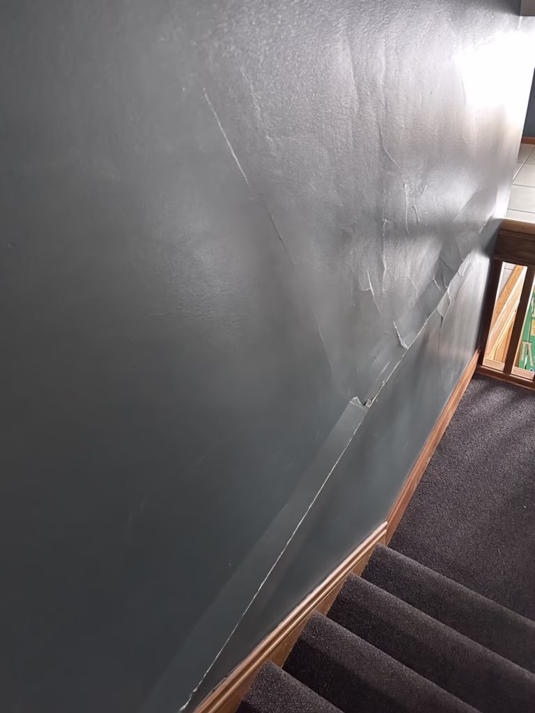 large horizontal plaster bulge in wall