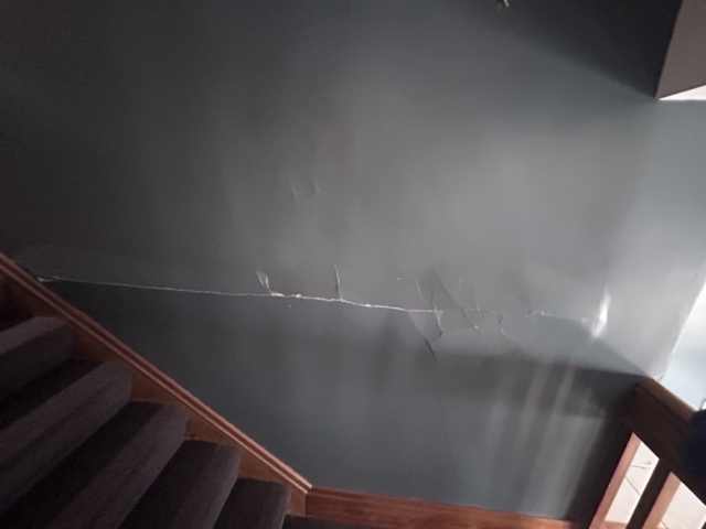 large horizontal plaster bulge in wall