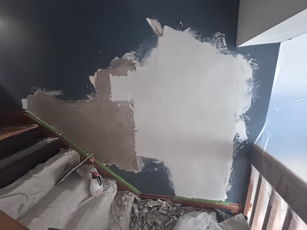 Plaster wall patch half finished with lime and plaster of paris