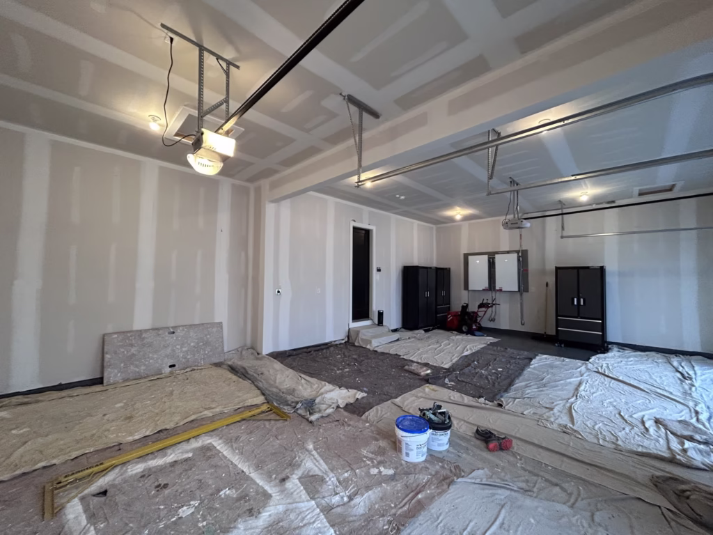 Different angle of unprimed drywall walls and ceiling in a residential two car garage in a new home in Clarence Center, NY.