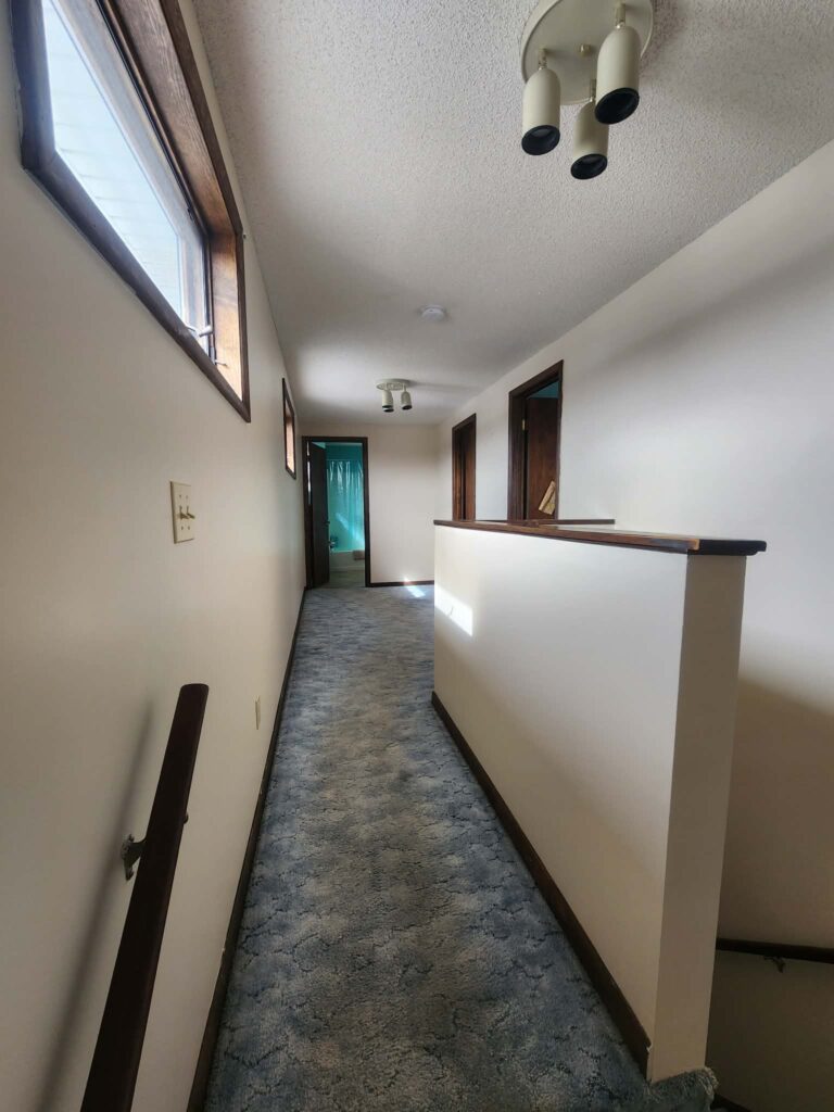 Second floor carpeted hallway that has been professionally painted.